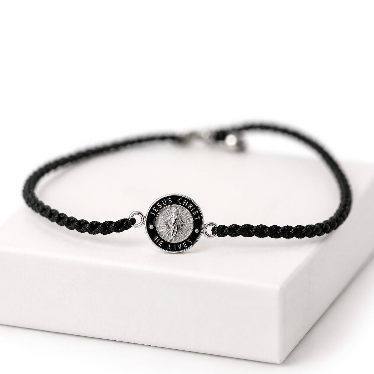Black cord He Lives bracelet with 11mm silver pendant