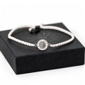 White cord He Lives bracelet with 11mm pendant on gift box