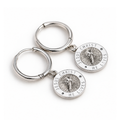 Silver and white Jesus Christ He Lives hoop earrings lying flat