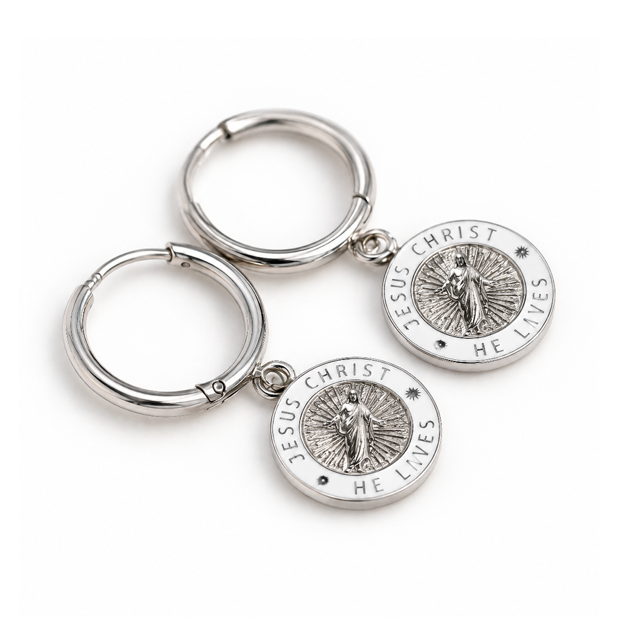 Silver and white Jesus Christ He Lives hoop earrings lying flat